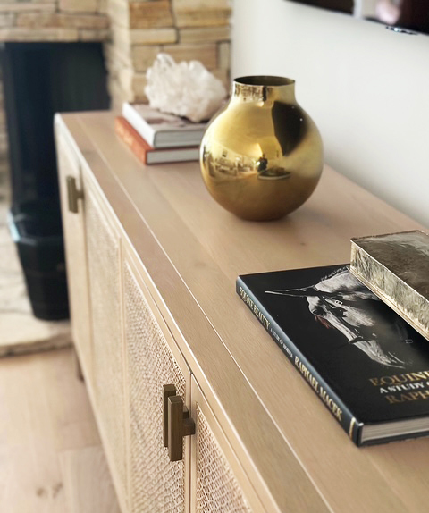 Console vignette with a gold vase and art books