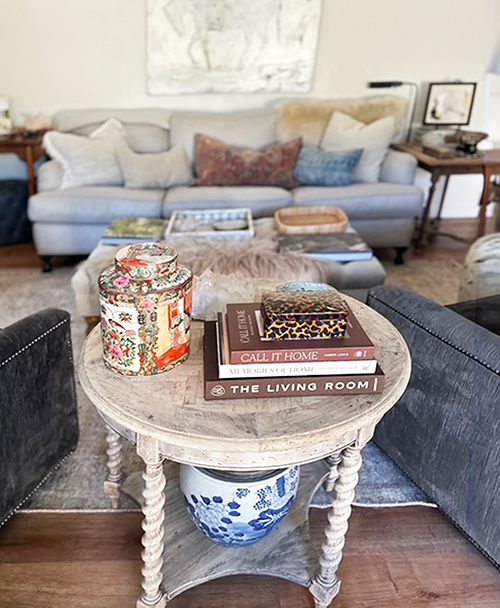 Collected living room vignette with books and ceramics