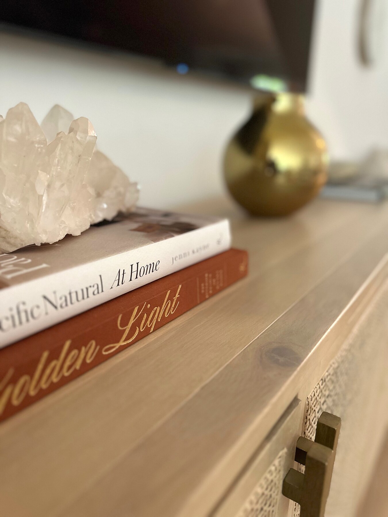 Books, crystal and brass vase vignette