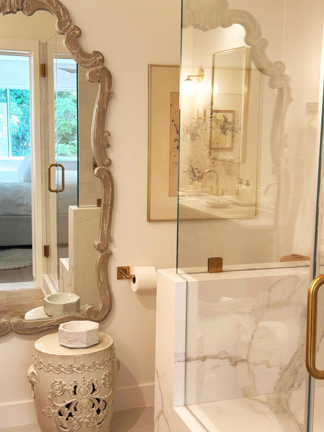 Refined marble bath with antique mirror and brass details