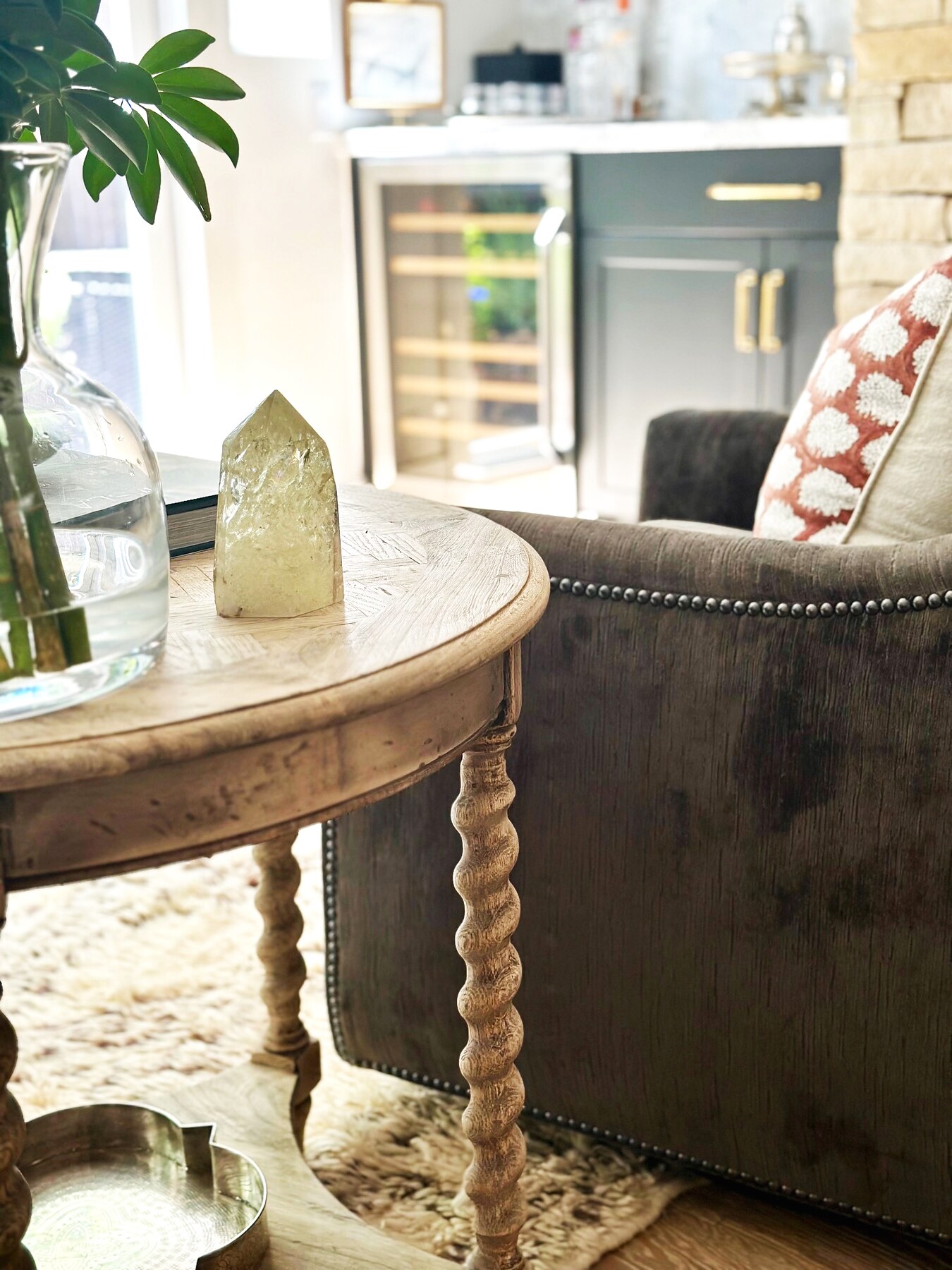 Crystal accent on an antique table beside a tailored chair