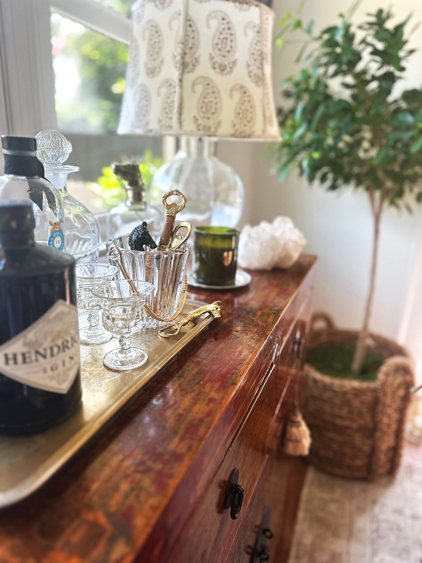 Layered bar vignette with glassware and warm wood